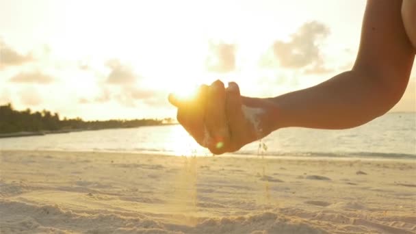 depositphotos_68768591-stock-video-female-playing-with-sand-on